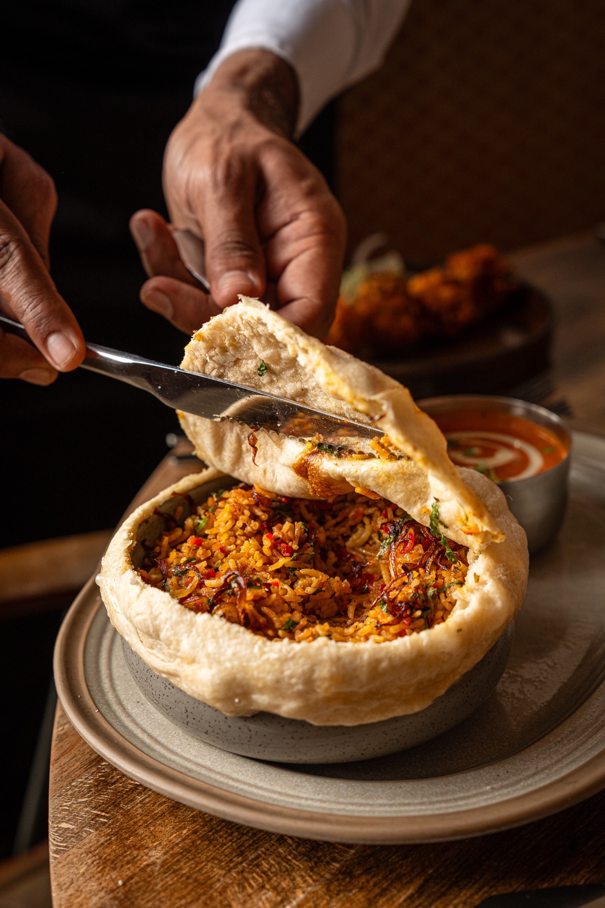 Dum biryani sealed in dough, cracked open at the table