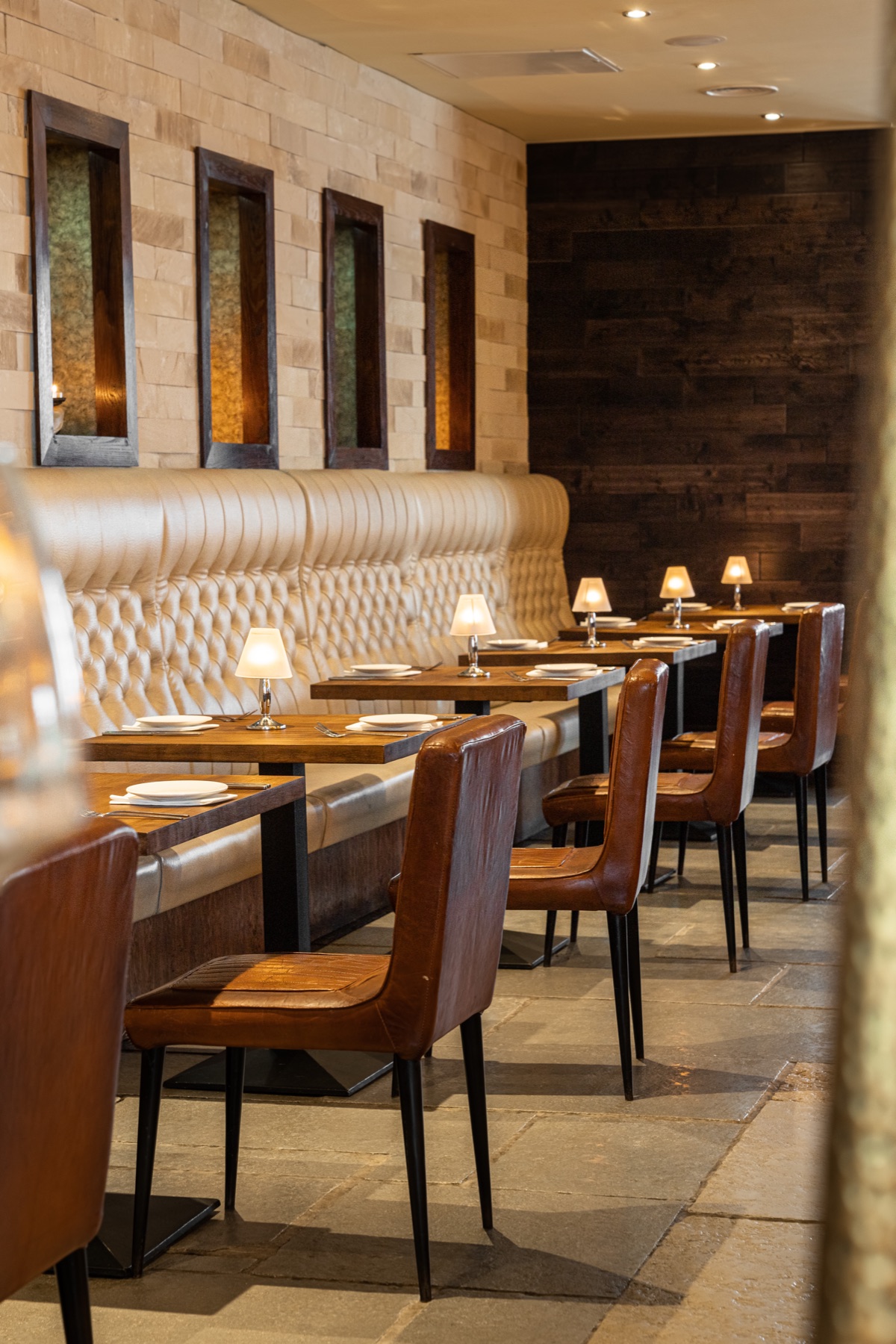 Tufted banquette seating with table lamps